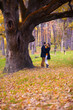 Smiling young couple in love having fun in the park on a beautiful autumn day