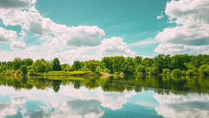 Wall Mural - Hyperlapse Summer Cloudy Sky Above Summer River Landscape Lake. Time lapse. 4K Timelapse. Sky Clouds Reflections In Water. zoom out