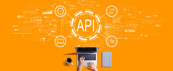 API - application programming interface concept with person working with a laptop