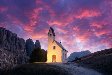Wall Mural - incredible view on small iilluminated chapel - kapelle ciapela on gardena pass, italian dolomites mo