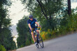 © Solid photos - Young sports man cycling with bicycle on the road in summer