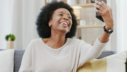 Poster - Black woman posing and taking selfies and making a peace hand gesture with her phone at home. One happy and cheerful female having fun taking photos for her social media while relaxing on the couch