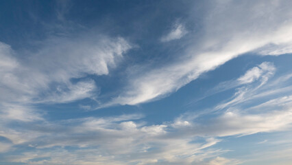 Wall Mural - beautiful wind shaped clouds and blue sky for background use or sky substitution