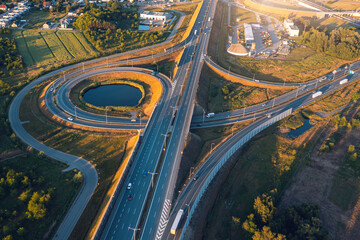 Aerial view of highway and roundabout at sunset in the evening