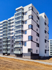 New modern apartment building against blue sky. 