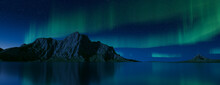 Green Aurora Lights Over Rugged Landscape. Beautiful Northern Lights Background With Copy-space.