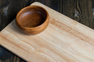 Wall Mural - wooden plate on cutting board and black wooden table