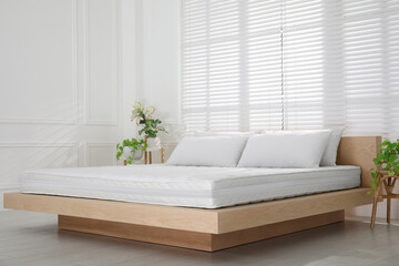 Wall Mural - Wooden bed with soft white mattress and pillows in cozy room interior