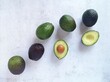 Avocados of varying degrees of maturity, top view