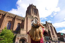 Tourism In Liverpool, UK. Back View Of Traveler Girl Visiting The Cathedral Church Of Christ In Liverpool, England.