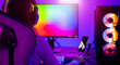 © sorapop - Asian professional gamer playing online video game on desktop computer PC have colorful neon LED lights, young woman in gaming headphones using computer for playing game at home