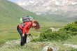 © Antonioguillem - Exhausted hiker resting in a high mountain field