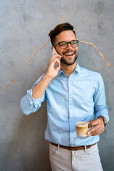 Wall Mural - Portrait of successful businessman talking on smartphone in coffee break in office