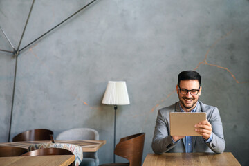 portrait of young business man working on digital tablet