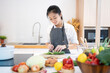 © PBXStudio - Asian woman cooking at home
