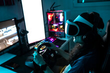 Gamer Wearing VR Glasses Using Steering Wheel At Home