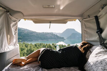 Woman Relaxing In Van On Vacation