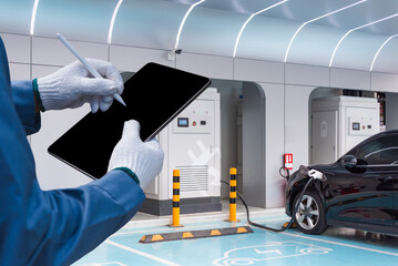 Wall Mural - Car Service Technician or Mechanic Uses a Tablet Computer with a Futuristic Interactive Diagnostics Software. Specialist Inspecting the Vehicle in Order to Find Broken Components In the Engine Bay.