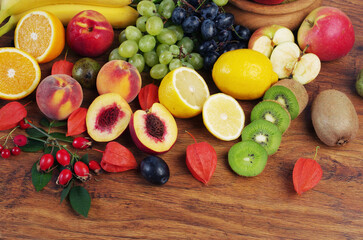  A variety of fresh ripe fruits on a wooden table.