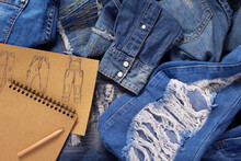 Jeans Denim With Designer Drawing Sketches. Blue Jeans As Background Texture