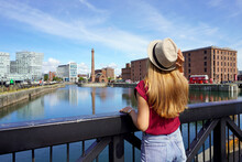 Tourism In Liverpool, UK. Back View Of Traveler Girl On Swing Bridge Visiting The Royal Albert Dock In Liverpool, England.