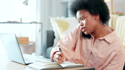 Canvas Print - Female student talking on a phone call while typing an academic essay or doing a homework assignment alone at home. Young university or college student with afro getting help with drafting an email