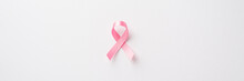 Top View Photo Of Pink Silk Ribbon Symbol Of Breast Cancer Awareness On Isolated White Background