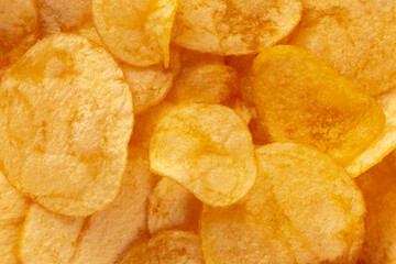 Poster - Potato chips texture, a salty snack, a pile of yellow crisps, top shot