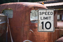 Speed Limit Sign Next To An Old Red Rusty Truck