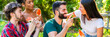 © GiuseppeElioCammarat - young people eating watermelon in park – happy friends eating watermelon in a park party – happy young friends eating cucumber - web banner for header