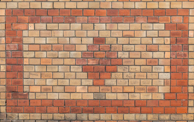 Old brick wall with pattern, old texture of red and yellow stone blocks. Background