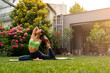 Amazing girl in attractive yoga pose in Mediterranean garden