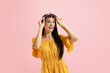 © master1305 - Portrait of young beautiful girl, student in summer yellow dress isolated on pink background. Concept of beauty, art, fashion, human emotions