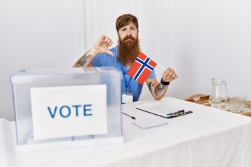 Canvas Print - Caucasian man with long beard at political campaign election holding norwegian flag with angry face, negative sign showing dislike with thumbs down, rejection concept