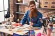 © Krakenimages.com - Young redhead man artist smiling confident drawing on notebook at art studio