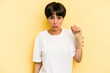 Young caucasian woman hand sling isolated on yellow background shrugs shoulders and open eyes confused.