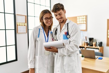 Two hispanic doctor working in a medical meeting at the clinic office.