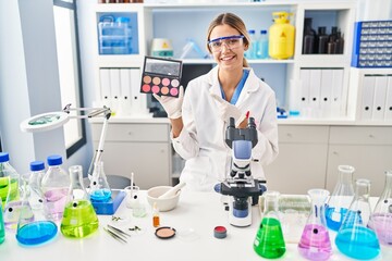 Poster - Young blonde woman working at scientist laboratory with make up smiling happy pointing with hand and finger