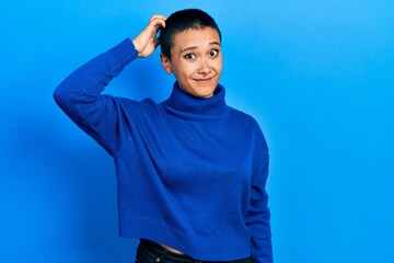 Sticker - Beautiful hispanic woman with short hair wearing turtleneck sweater confuse and wonder about question. uncertain with doubt, thinking with hand on head. pensive concept.