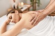 © Krakenimages.com - Woman smiling happy reciving back massage at beauty center.