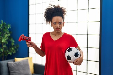 Poster - Young african american woman playing football video game skeptic and nervous, frowning upset because of problem. negative person.