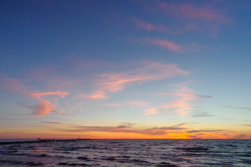 Wall Mural - Colorful orange sunset over Baltic sea on clear summer day
