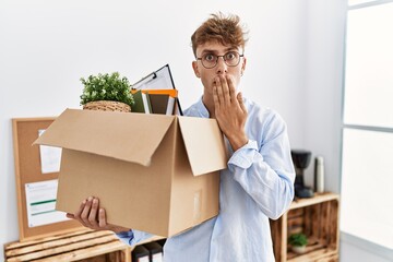 Sticker - Young caucasian man holding business box covering mouth with hand, shocked and afraid for mistake. surprised expression