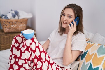 Sticker - Young woman talking on smartphone drinking coffee at bedroom