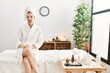© Krakenimages.com - Young blonde woman wearing bathrobe at wellbeing spa sticking tongue out happy with funny expression. emotion concept.