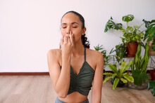 A Young Woman Meditates With Alternate Nostril Breathing To Calm Anxiety