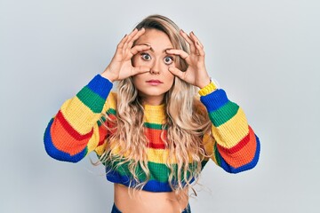 Sticker - Beautiful young blonde woman wearing colored sweater trying to open eyes with fingers, sleepy and tired for morning fatigue