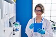 © Krakenimages.com - Young woman scientist using touchpad at laboratory