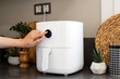 Woman cooking with modern Air fryer