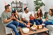© Krakenimages.com - Group of young hispanic friends having birthday party playing funny game at home.